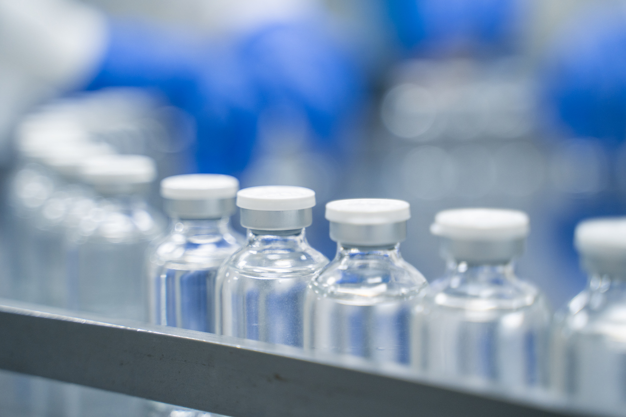 Sterile glass vials on a pharmaceutical fill line in a cGMP cleanroom